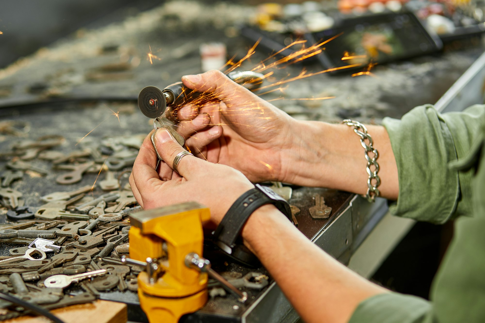 Locksmith in workshop makes new key, use grinding engraving machine